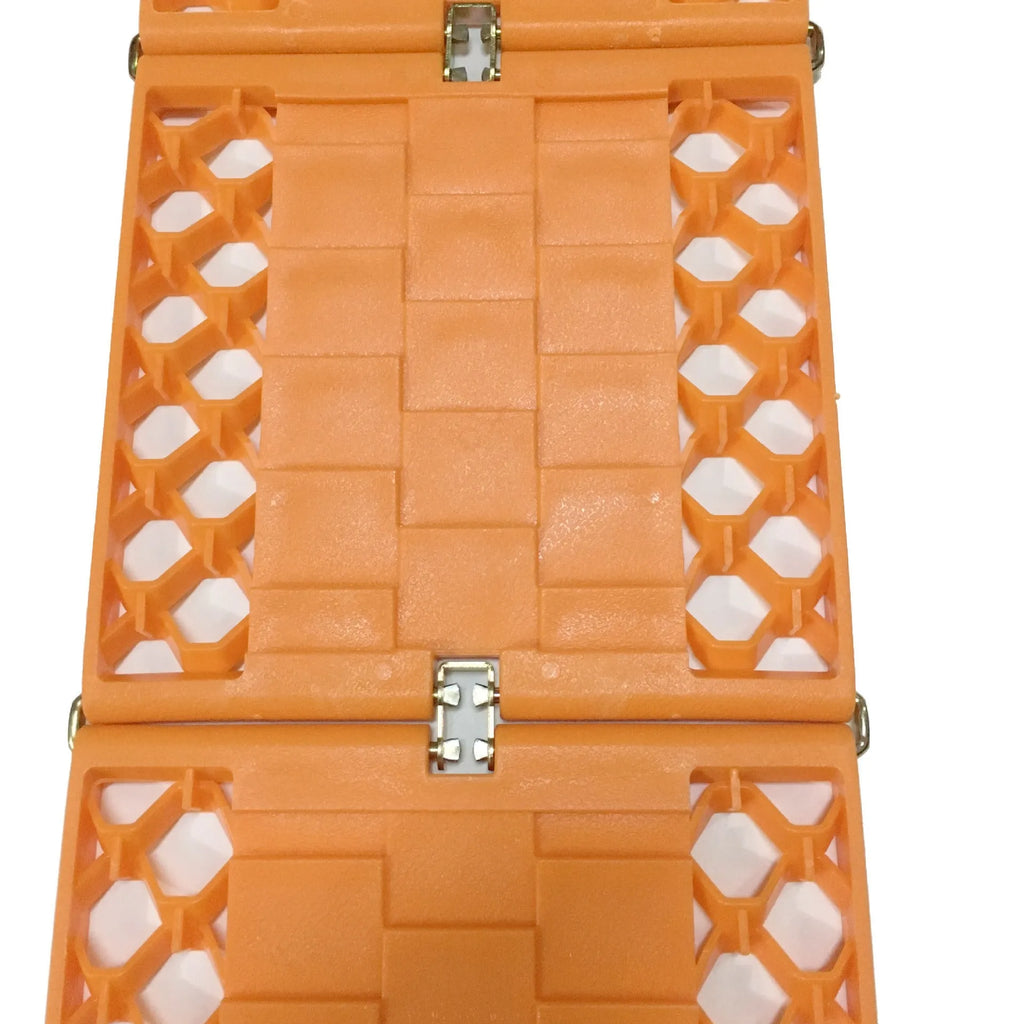Orange folding rescue boards for vehicle recovery in mud and snow conditions