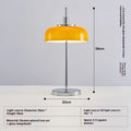 Retro table lamp with glass lampshade and chrome finish on a wooden surface