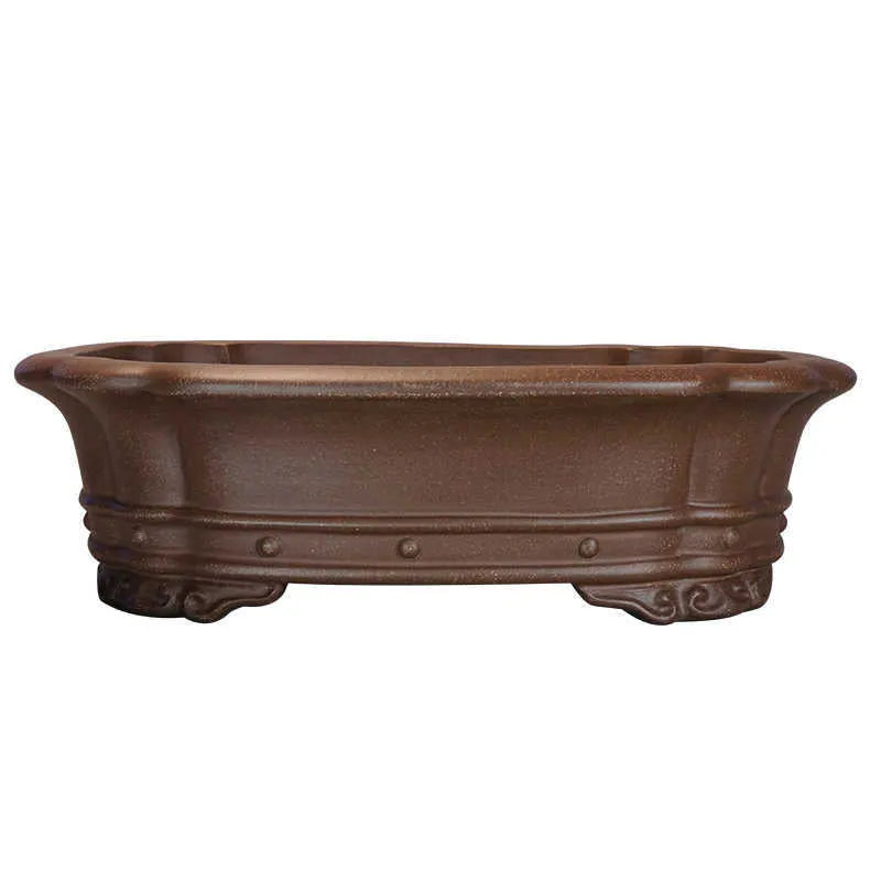 Purple clay handmade rectangular flower pot with antique design on wooden desktop