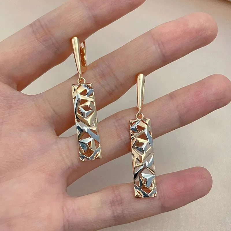 A pair of rectangular two-tone hollow stud earrings with a geometric design and electroplated alloy finish.