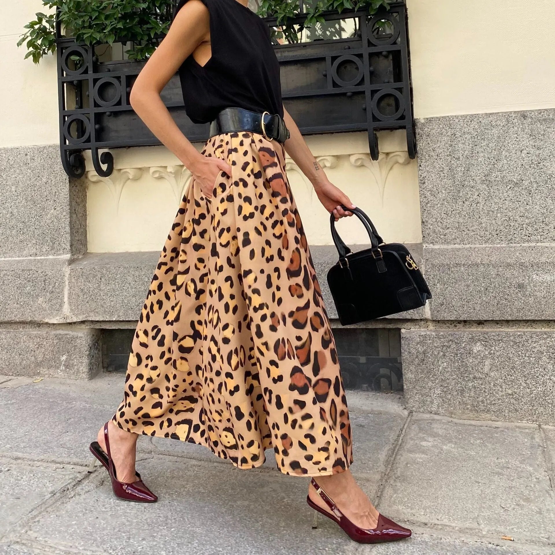Brown leopard print women's A-line long skirt with big hem design on mannequin