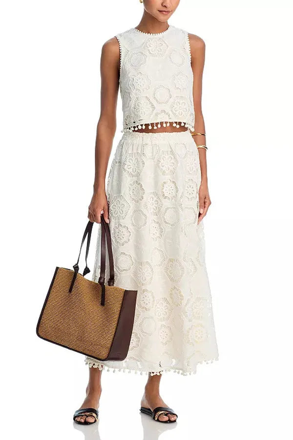 White women's retro style polyester suit with sleeveless top and embroidered long skirt.