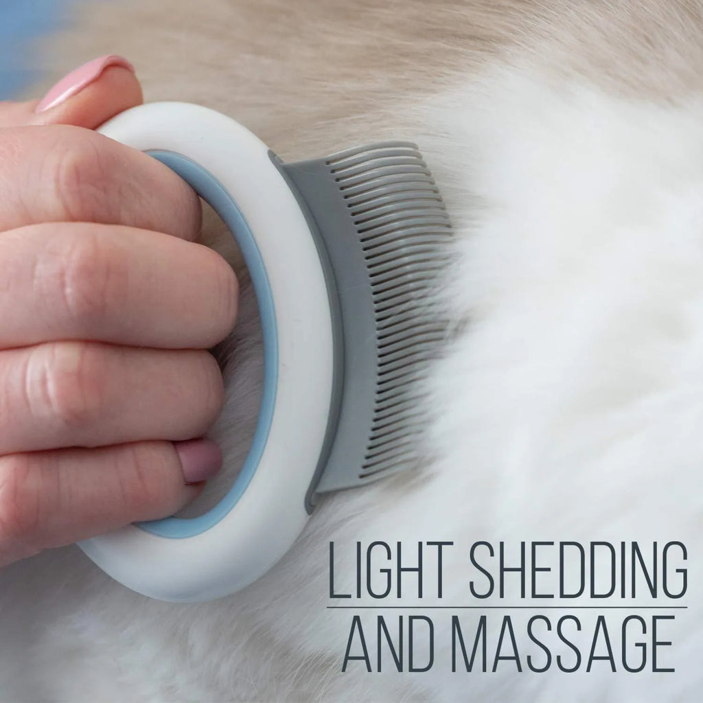 Blue pet grooming comb for cats and dogs on a white background, showing ergonomic handle and soft teeth.