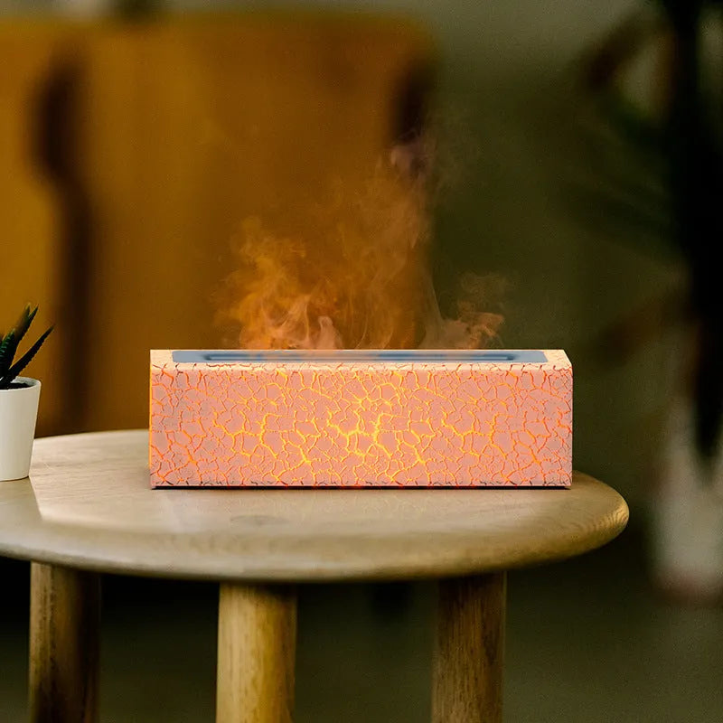 Square black creative lava USB humidifier and aroma diffuser with colourful LED flame lighting on a desk.
