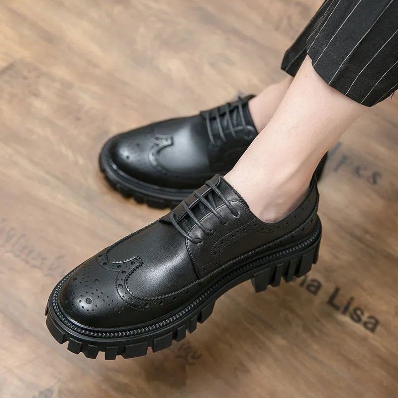 Men's black leather brogue shoes with round toe design on solid background