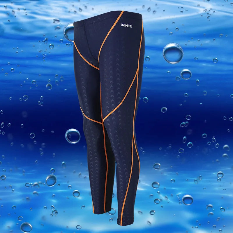 Men's nylon cropped swimming trunks in a black and green colour block design, laid flat.