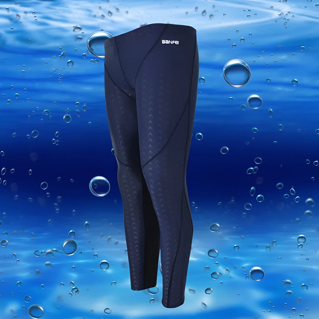 Men's nylon cropped swimming trunks in a black and green colour block design, laid flat.