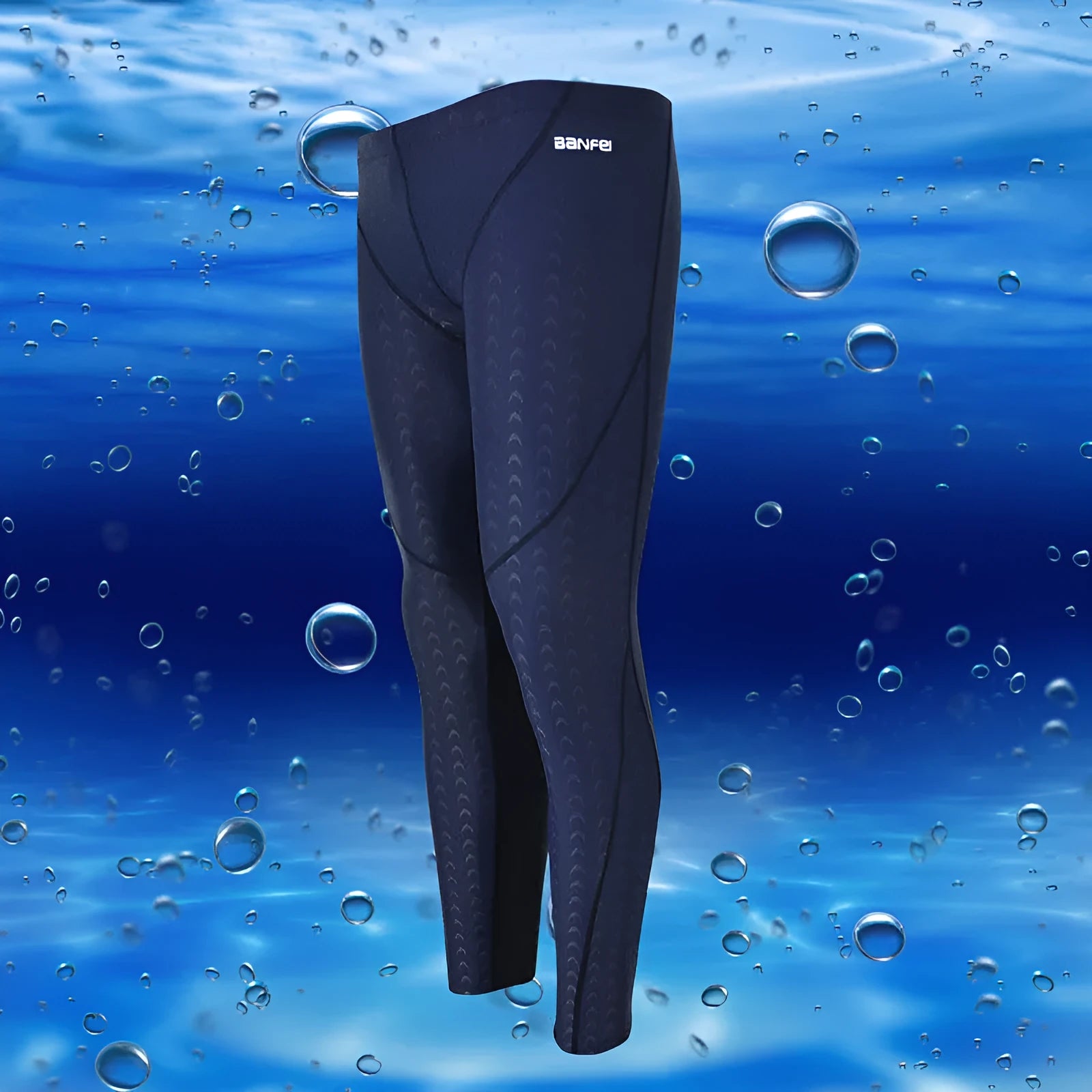 Men's nylon cropped swimming trunks in a black and green colour block design, laid flat.