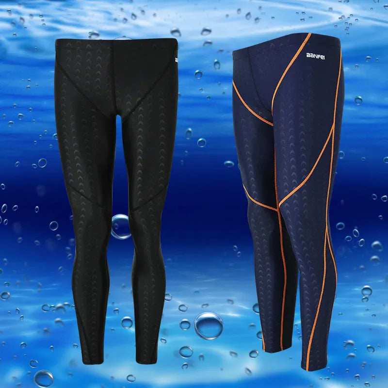 Men's nylon cropped swimming trunks in a black and green colour block design, laid flat.