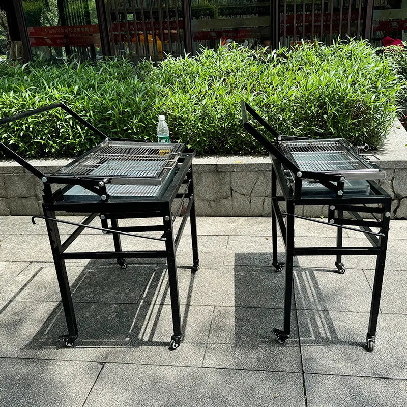Large foldable Flip BBQ charcoal grill with detachable legs set up in a garden.