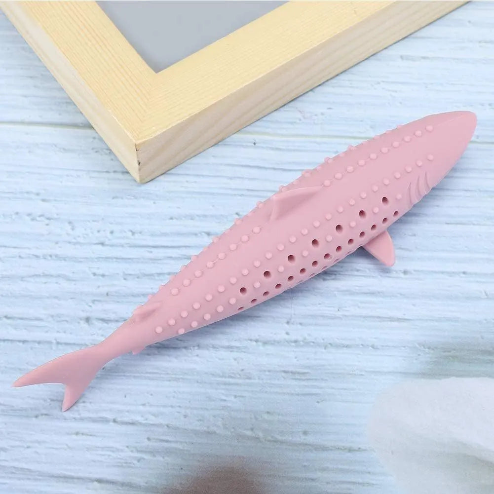 Green silicone fish-shaped cat chew toy with side holes on a white background.