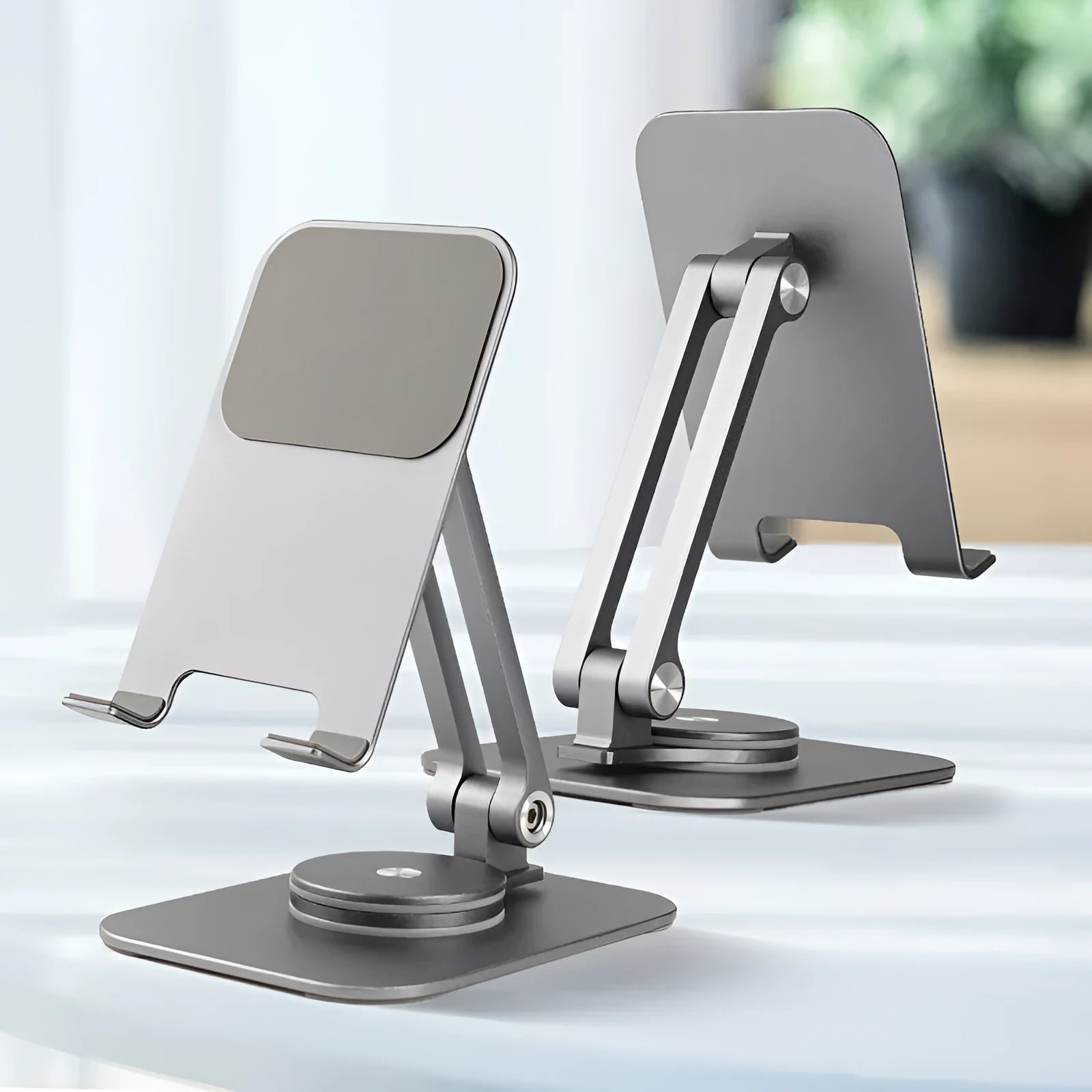 Aluminium alloy rotary desktop mobile phone holder in silver grey with silicone pad, unfolded on desk