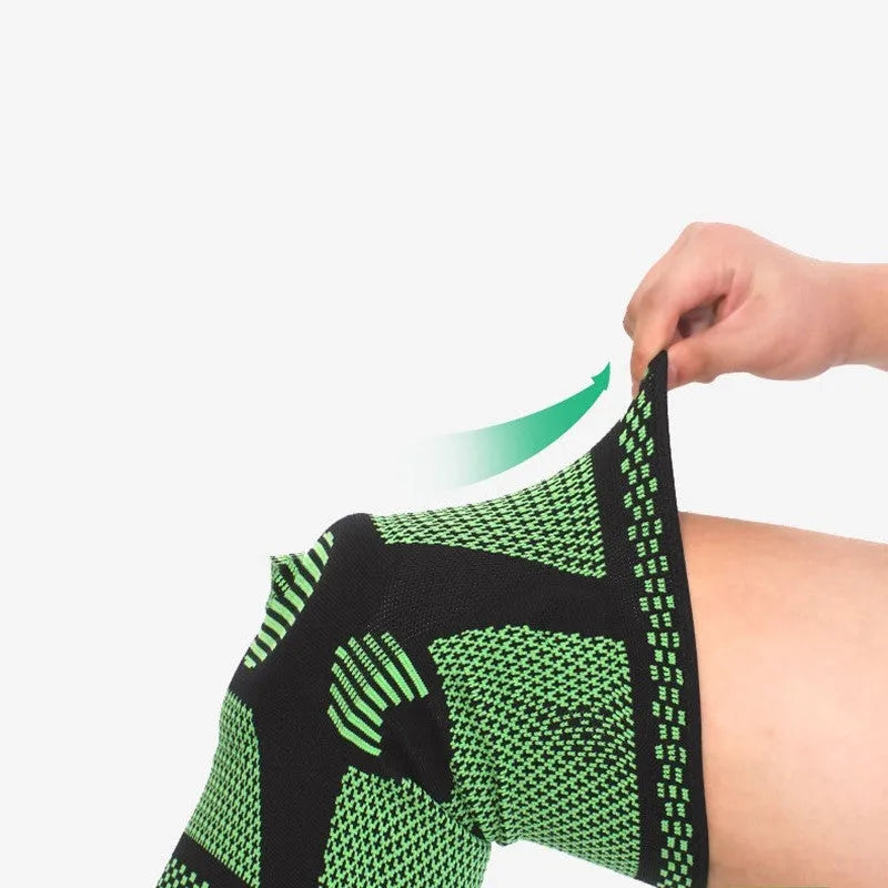 Green polyamide sports knee pad shown on leg, sizes M L XL for 35-55cm leg circumference.