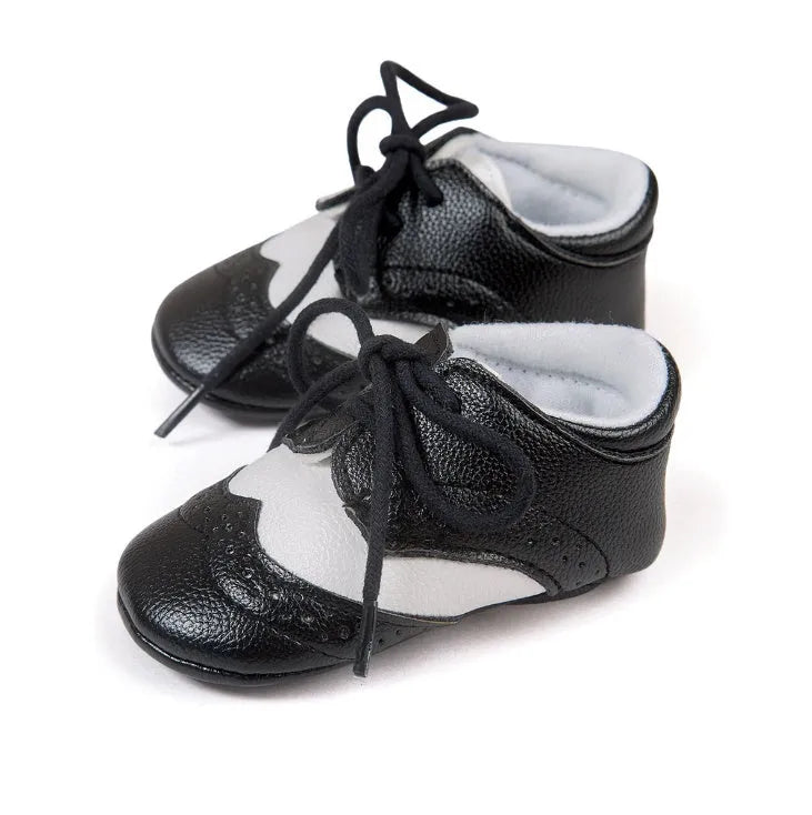 Vintage style soft-soled baby walking shoes for boys in black, grey, light brown, and white.