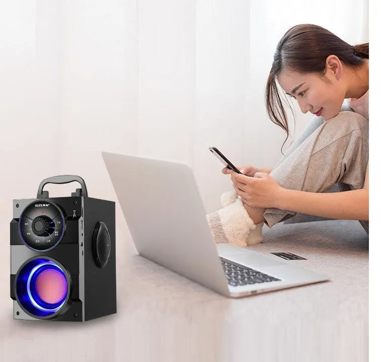 Black portable mini audio system with satellite speakers and subwoofer unit showing 3.5mm audio cable
