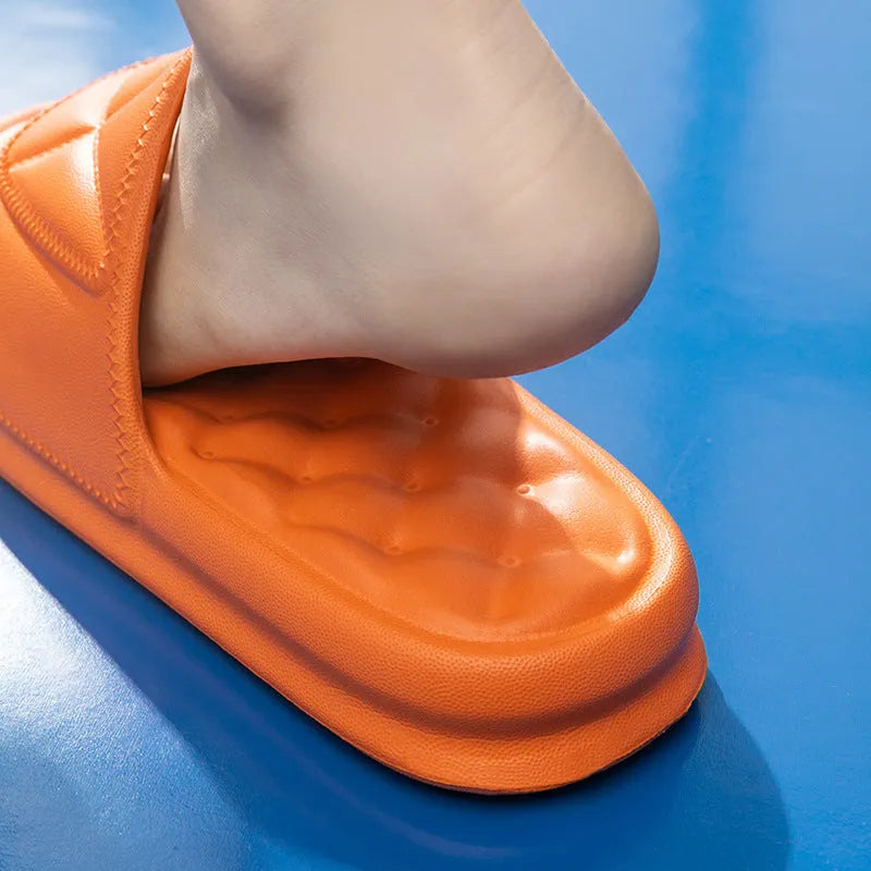 Unisex thick sole EVA bathroom slippers in black, shown on a wet tile floor.