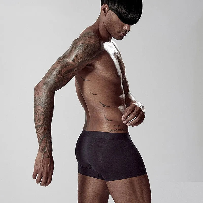 Seamless one-piece men's modal underwear in mid-waist design shown in green colour