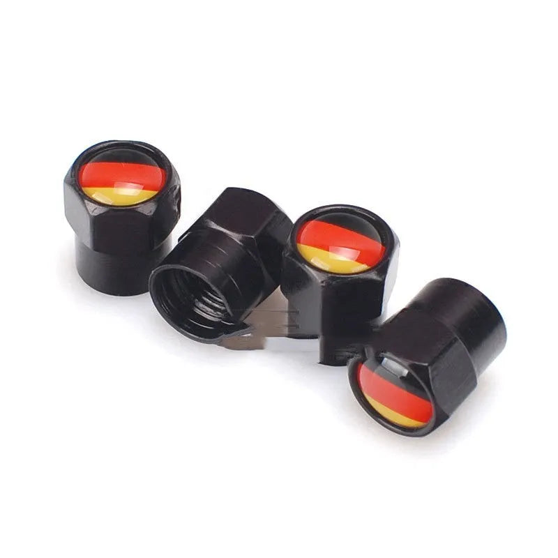 Set of four black metal aluminium alloy valve caps with German flag design on white background