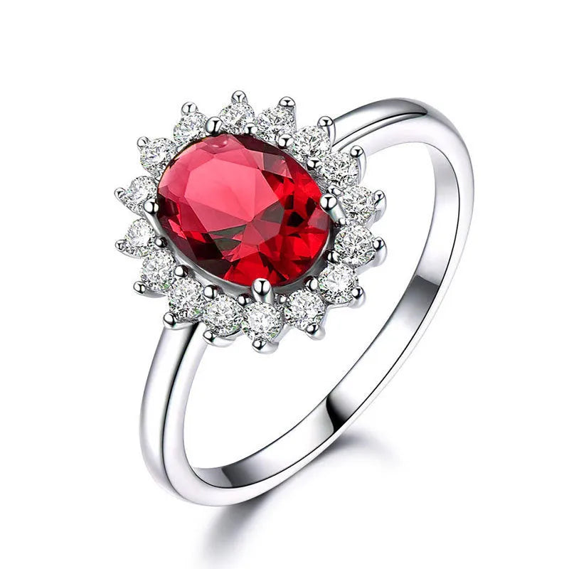 Women's copper floral ring with inlaid zirconium stones in green, blue, or red on a hand.