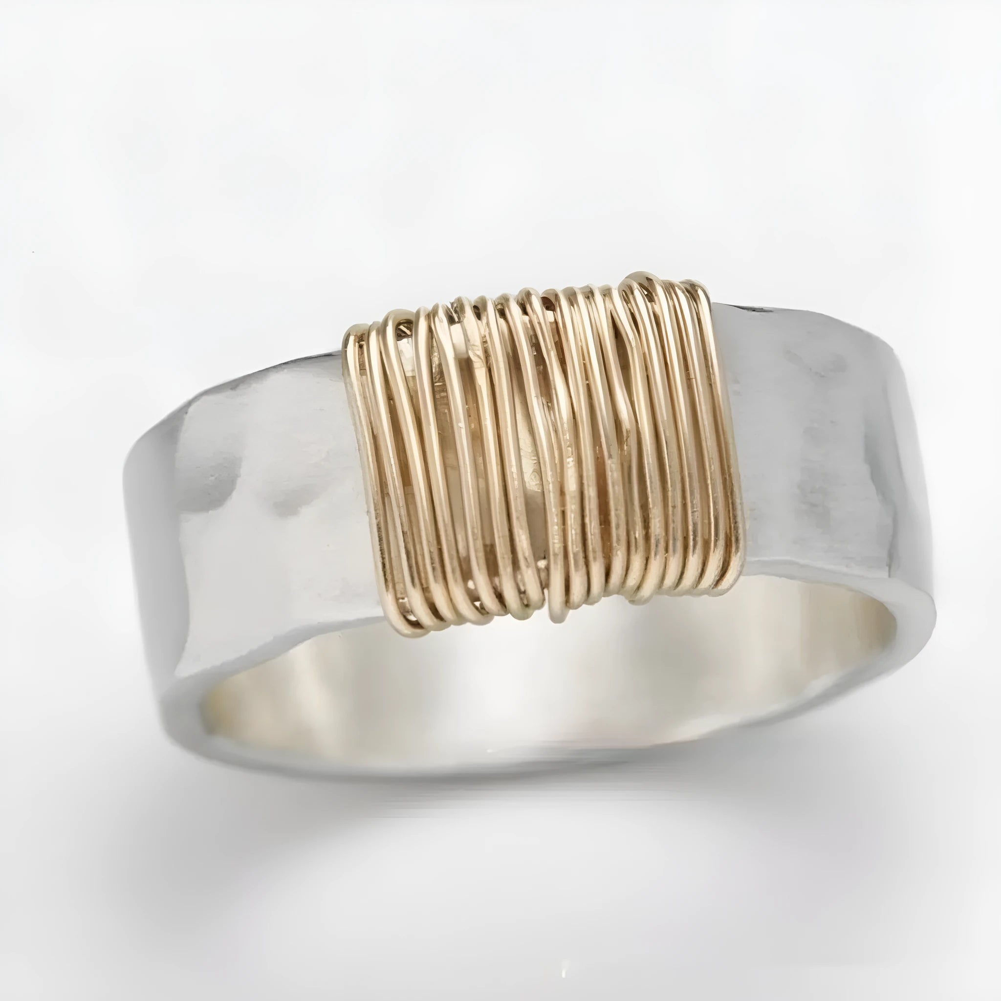 Simple geometric ring bracelet in electroplated copper with silver gold coil finish showing irregular coil design
