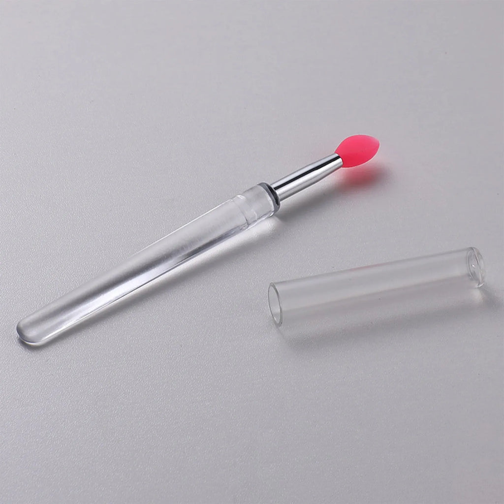 Reusable silicone lip brush with protective cap in one of eight colours: blue, pink, purple, red, rose red, skin colour, white, or yellow.