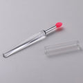 Reusable silicone lip brush with protective cap in one of eight colours: blue, pink, purple, red, rose red, skin colour, white, or yellow.