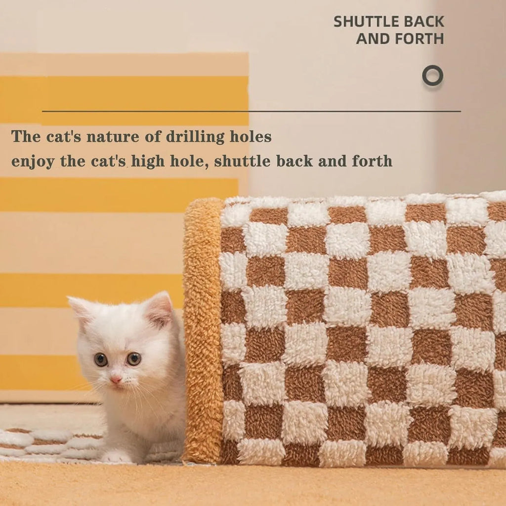 Brown plush plaid cat tunnel bed with a non-slip base on a wooden floor.