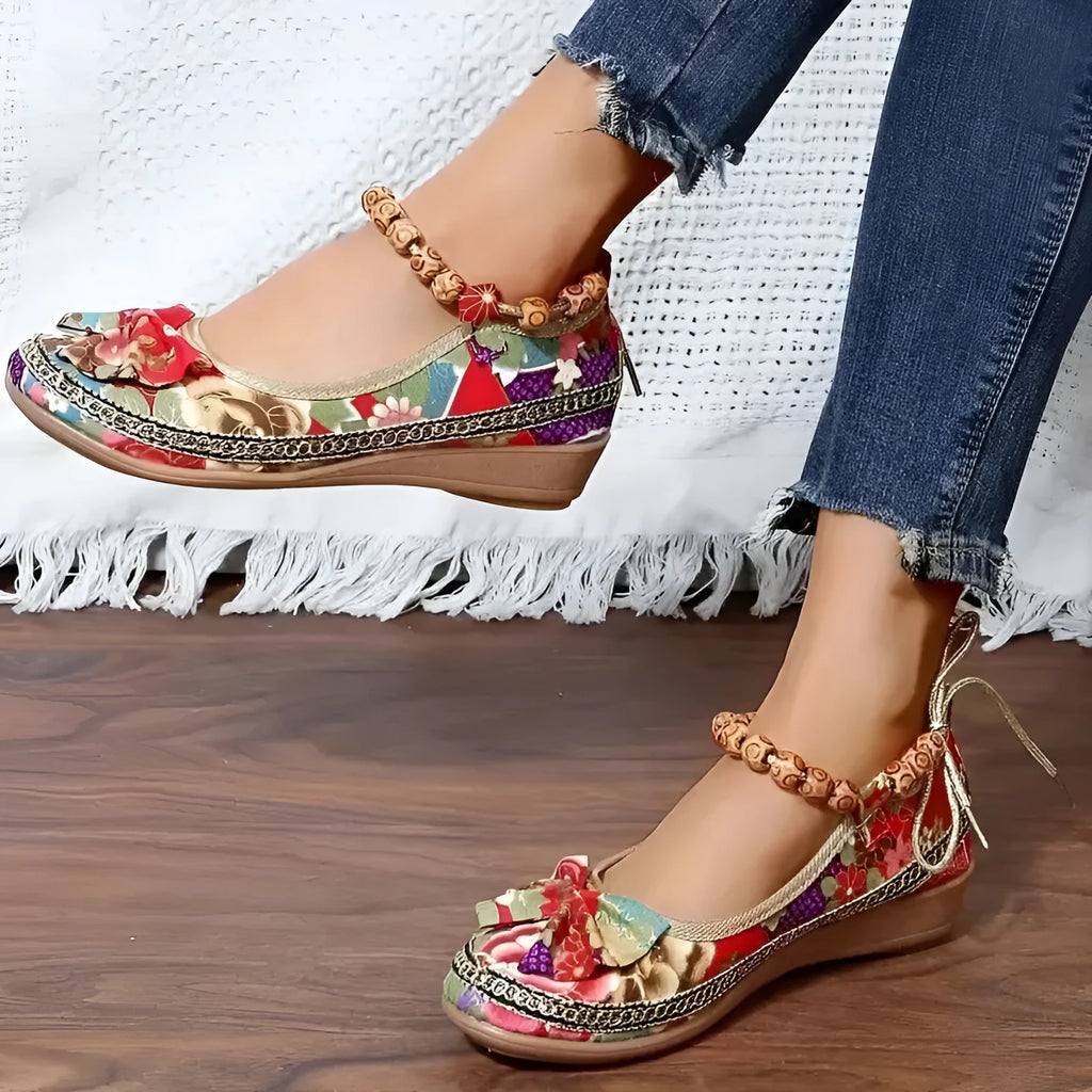 Women's black ethnic platform sandals with elastic band and cloth upper on a plus size foot.