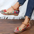 Women's black ethnic platform sandals with elastic band and cloth upper on a plus size foot.