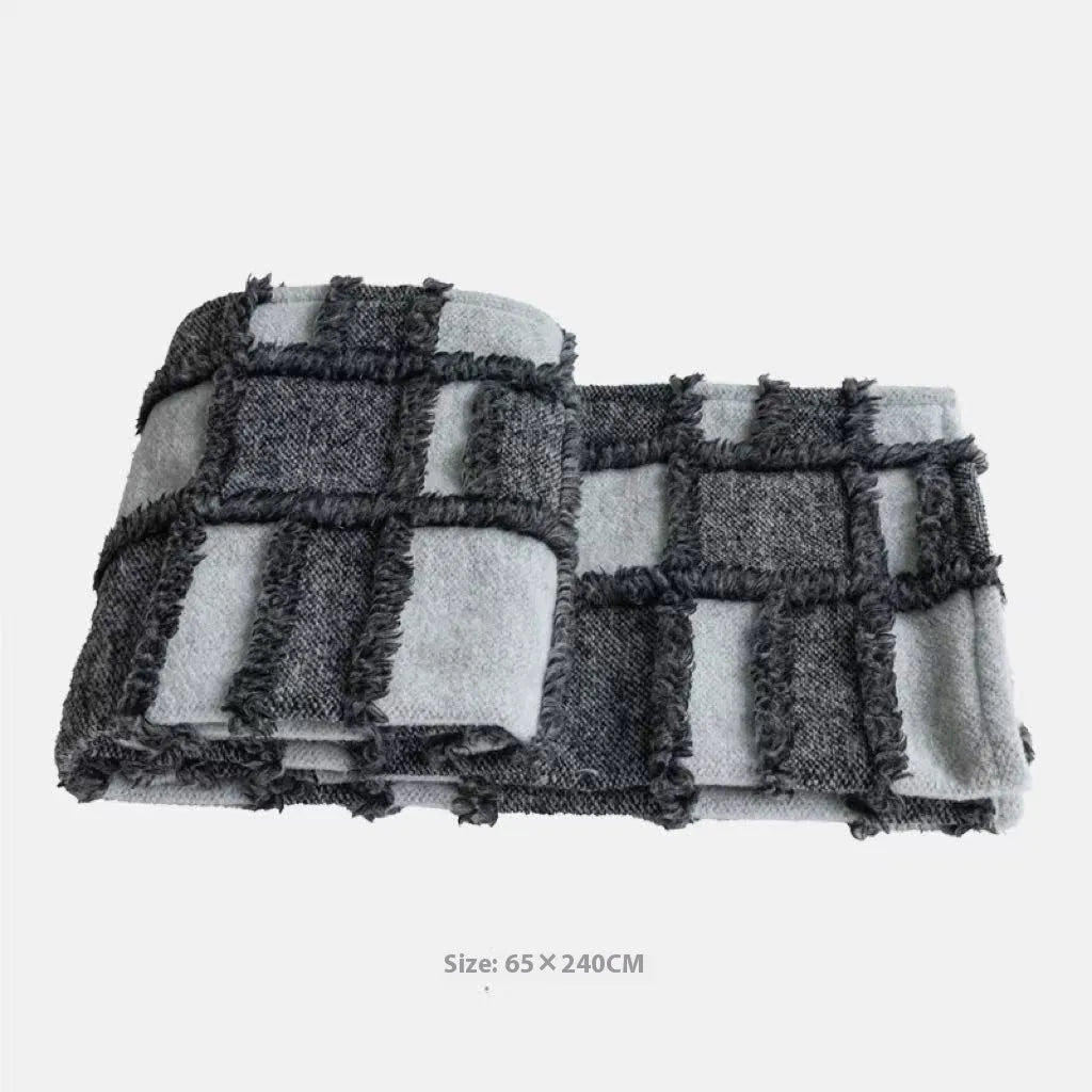 Modern minimalist grey and white plaid bed runner set with pillowcase and round leather pillow on bed