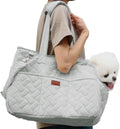 Grey pet carrier handbag with mesh panels and shoulder strap on a table