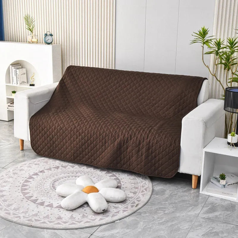 Waterproof reversible dog blanket on a sofa, showing two colour sides, with size chart for nine options.