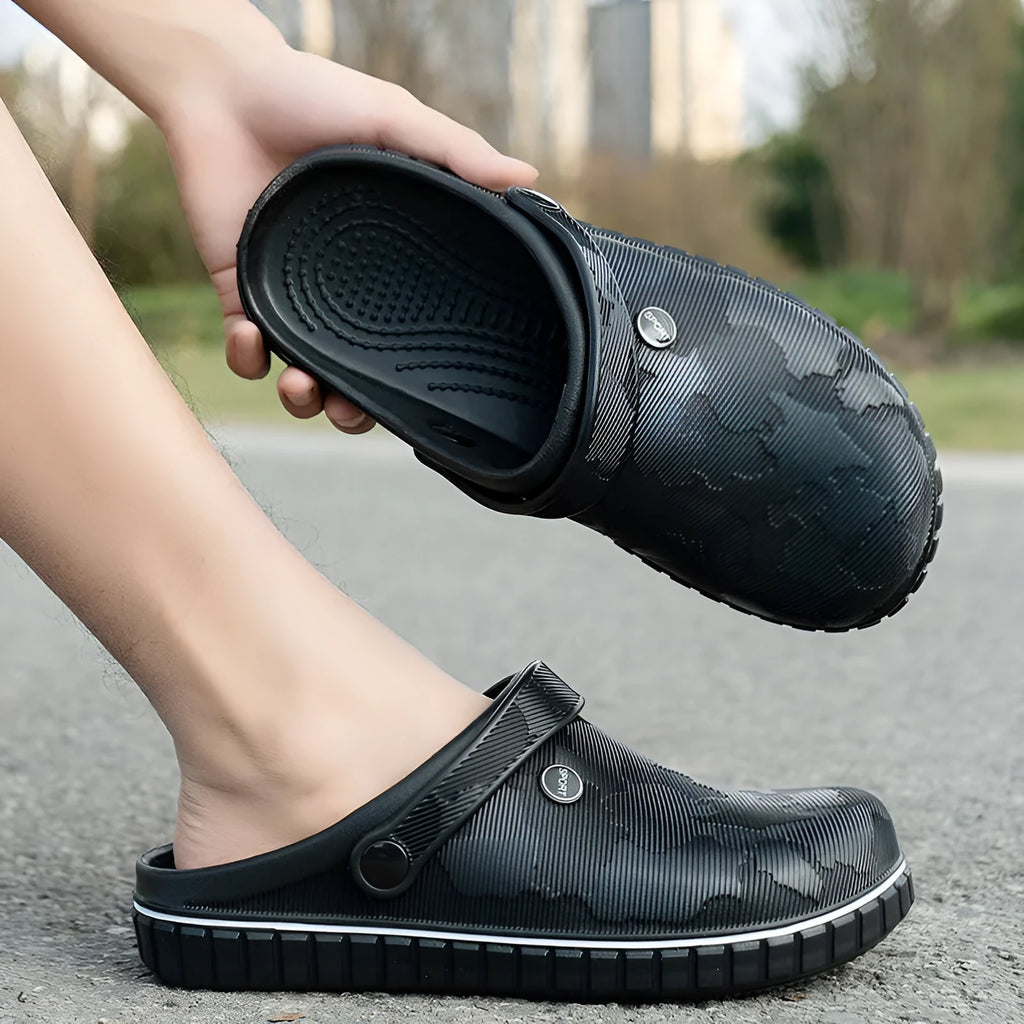 Men's casual beach sandals in black with flat heel, round toe, and EVA upper on a wooden floor