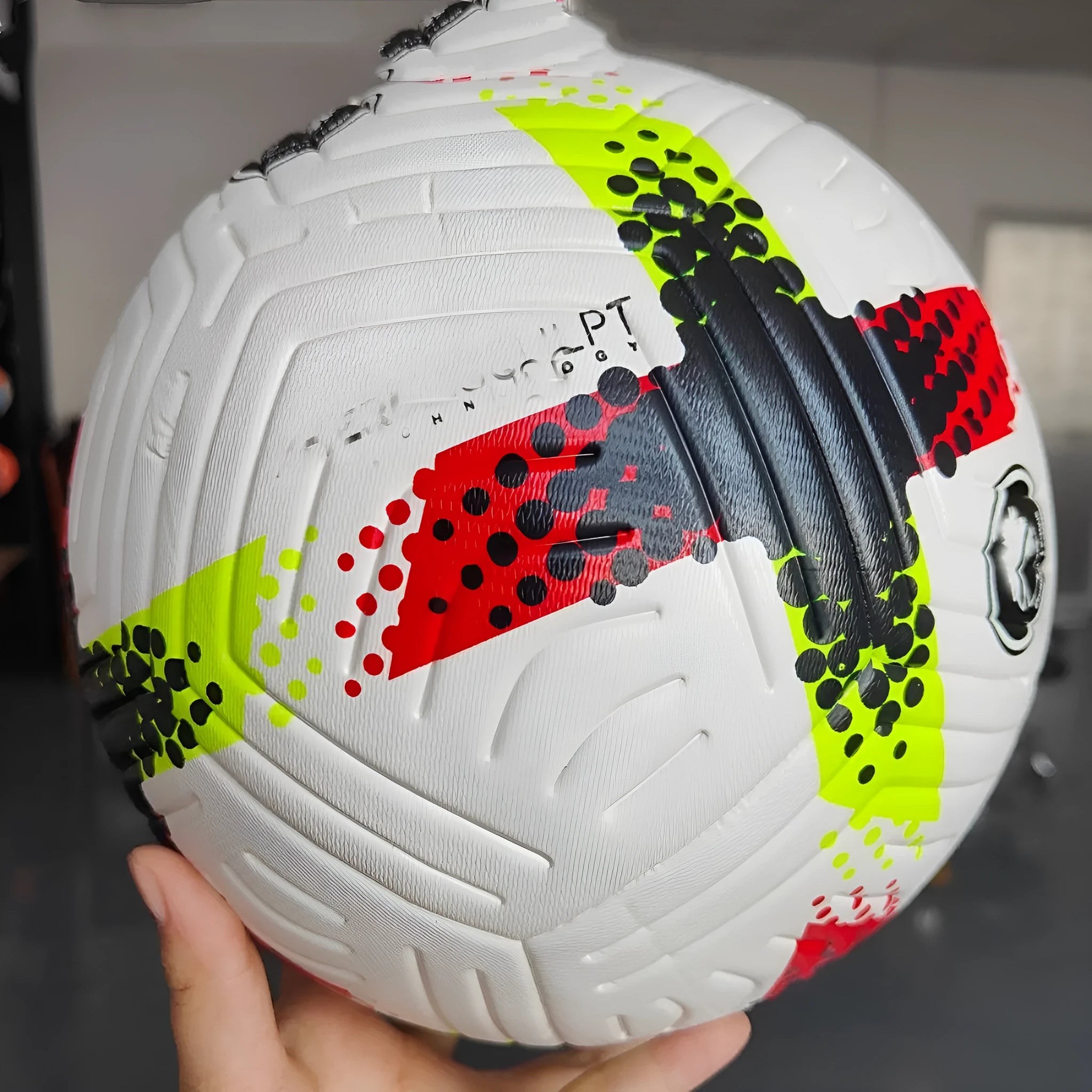 Fluorescent green Size 5 football on a pitch for training and matches.