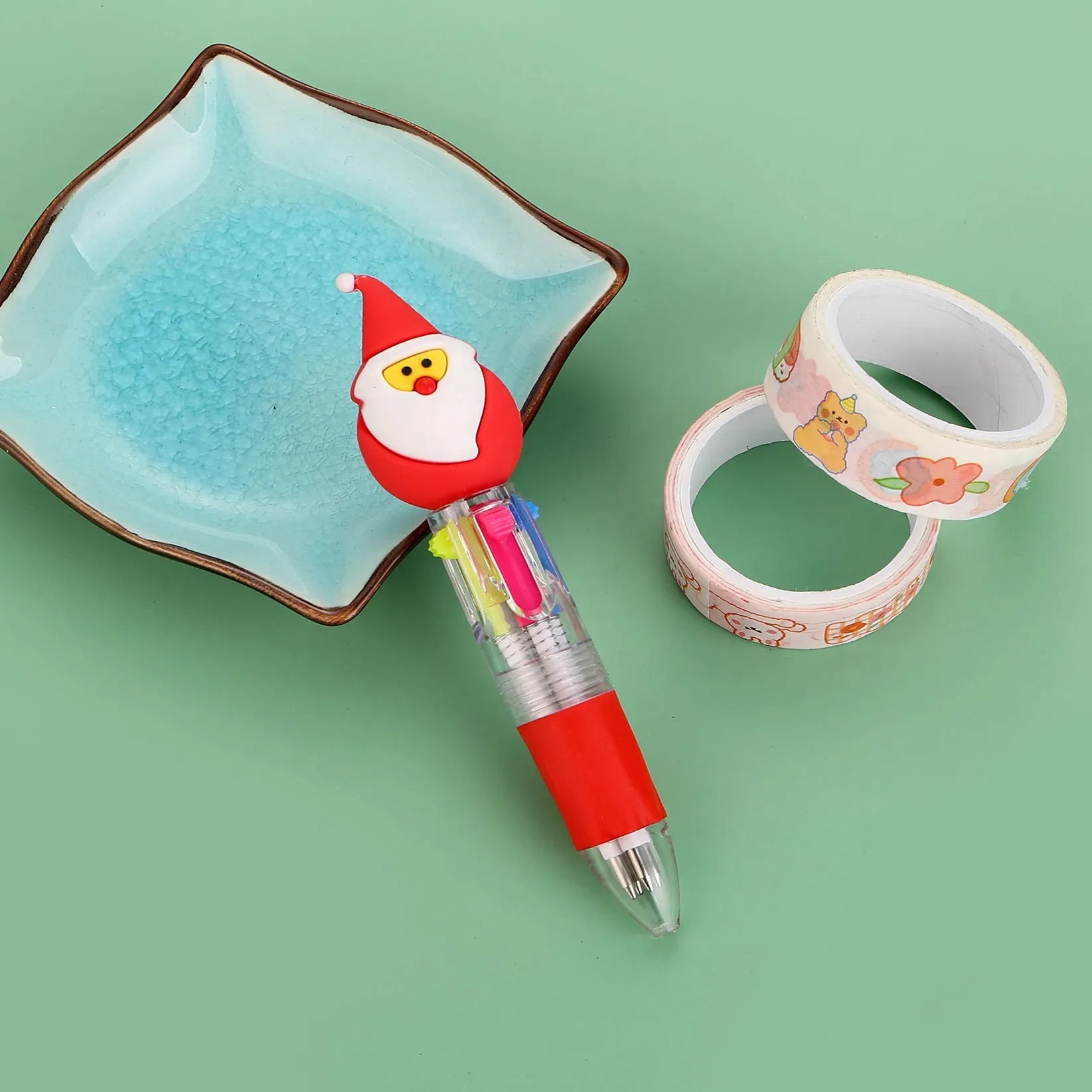 11cm long Christmas-themed four-colour ballpoint pen showing festive designs like reindeer and trees.