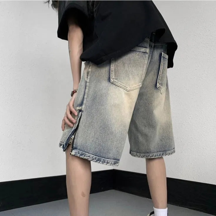 Blue retro tattered denim shorts with a wide leg loose fit on a mannequin.