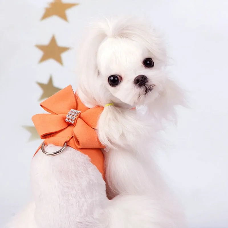 A soft microfiber dog chest strap with a decorative bowknot, shown in pink, blue, and orange colour options.