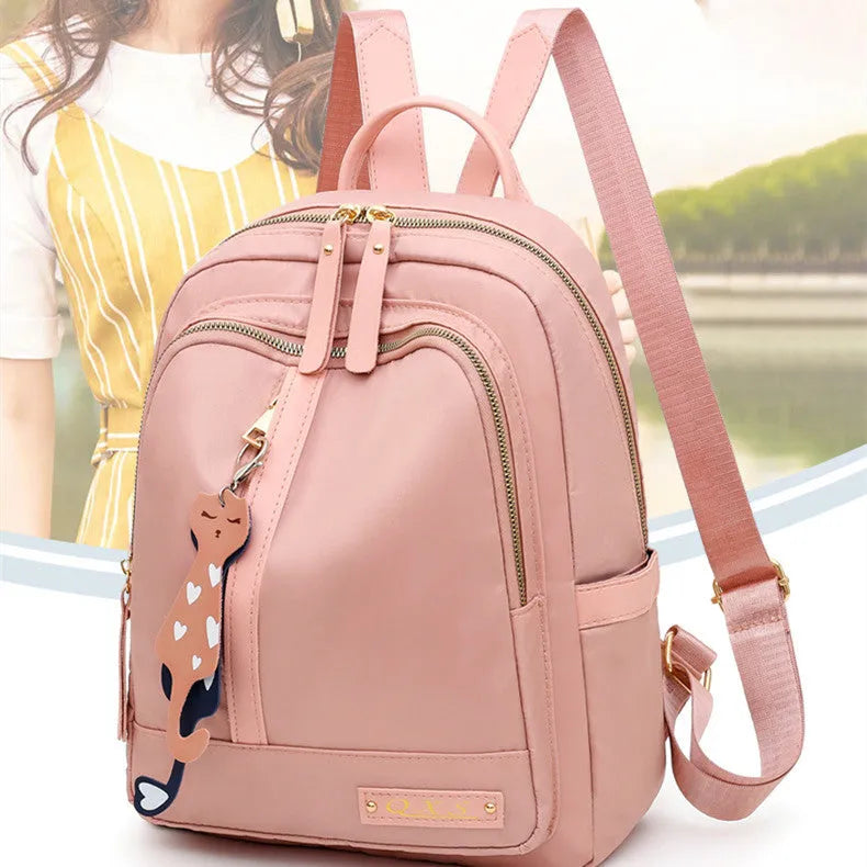 Women's black casual nylon backpack with double shoulder straps showing interior organisation compartments