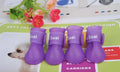 Soft silicone pet rain boots in royal blue on a wet pavement, non-slip sole visible