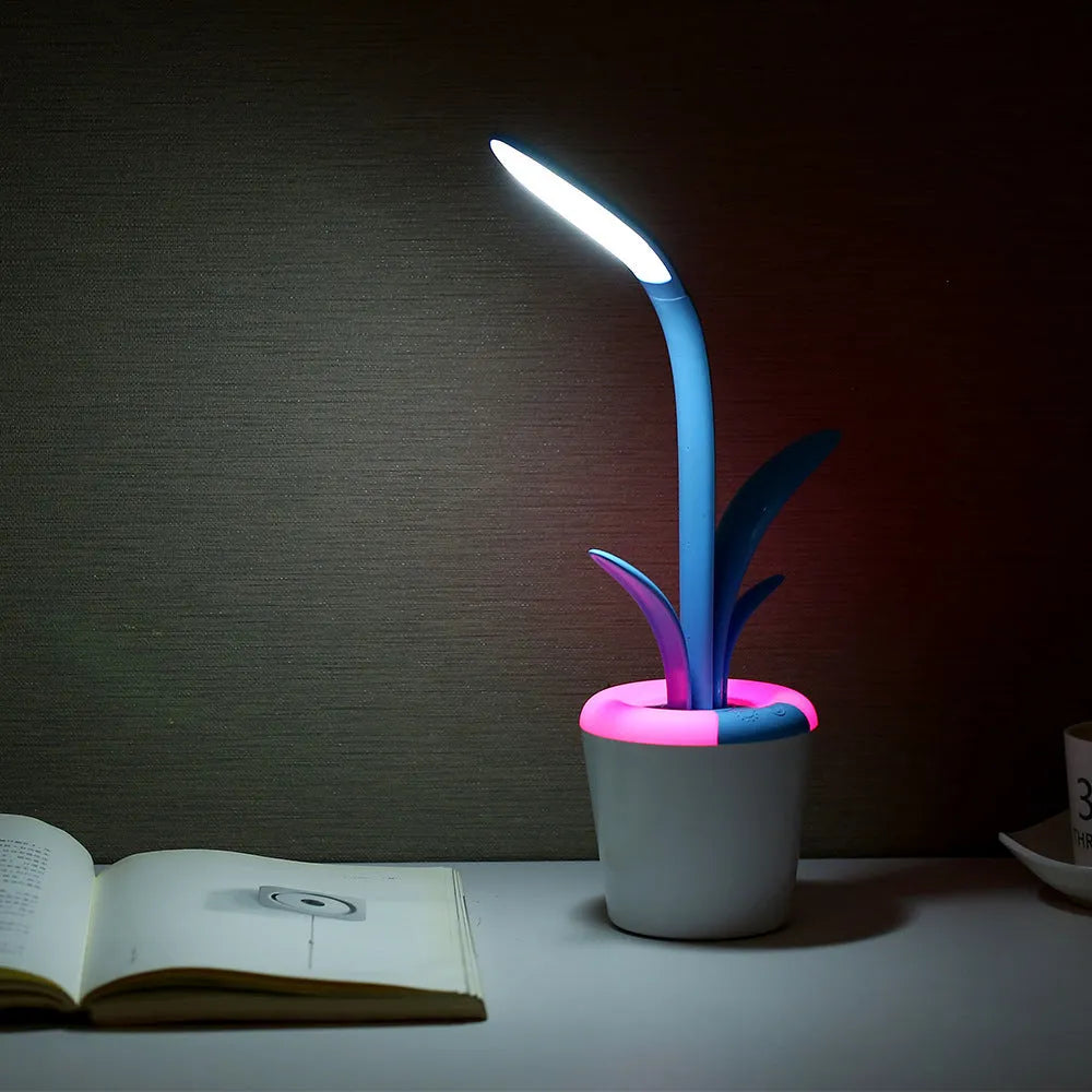 Modern rechargeable LED table lamp in blue with stylised plant shape on end table