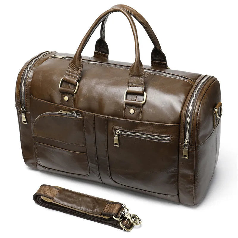 Coffee first layer cowhide leather travel bag with soft handle and zip closure on a plain background