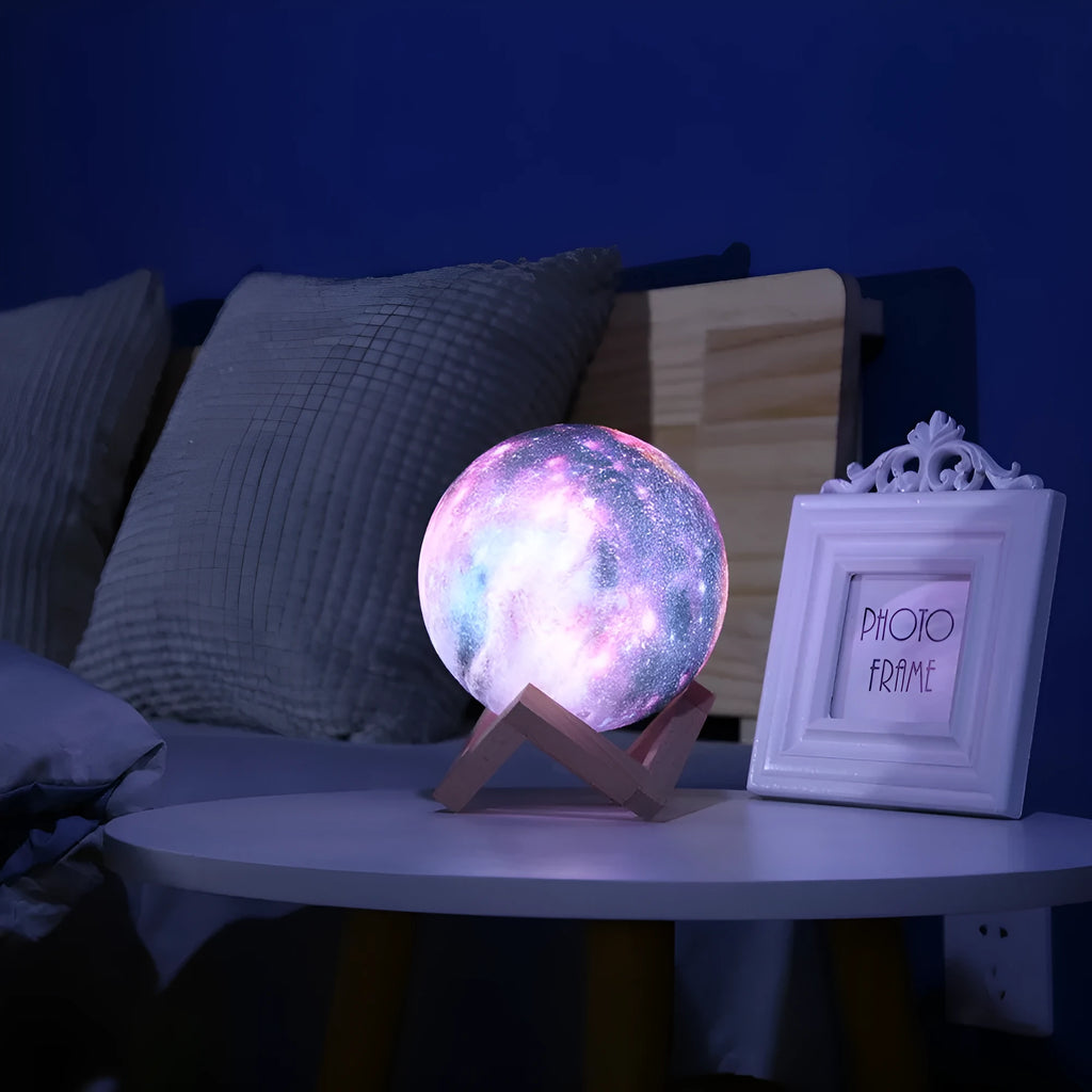 3D printed spherical moon lamp glowing on a surface, showing its textured lunar surface and soft LED light.