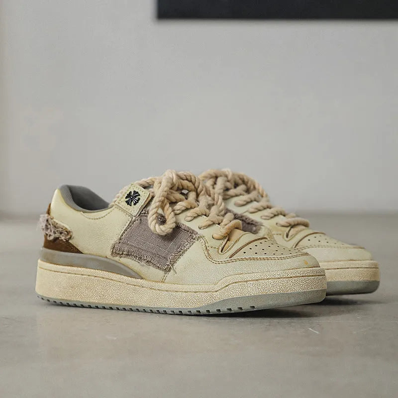 Beige vintage patch skateboard shoes with low-top design and round toe
