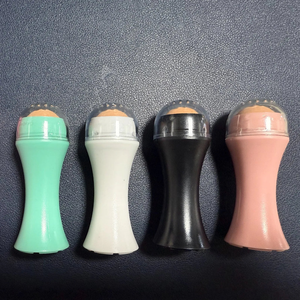 Portable volcanic stone roller for absorbing facial oil, shown in black, green, pink, and white colour options.
