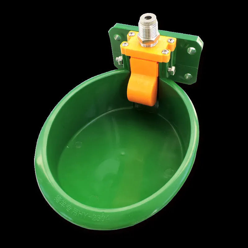 Green plastic livestock drinking bowl for sheep and pigs on farm