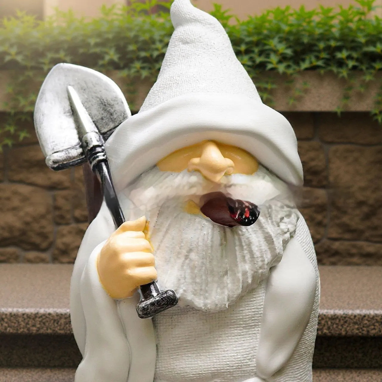 Christmas garden ornament with pipe dwarf holding smoking shovel, plastic and resin construction