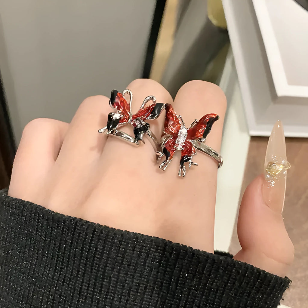 Creative copper butterfly ring with dripping oil finish, showing open loop design.
