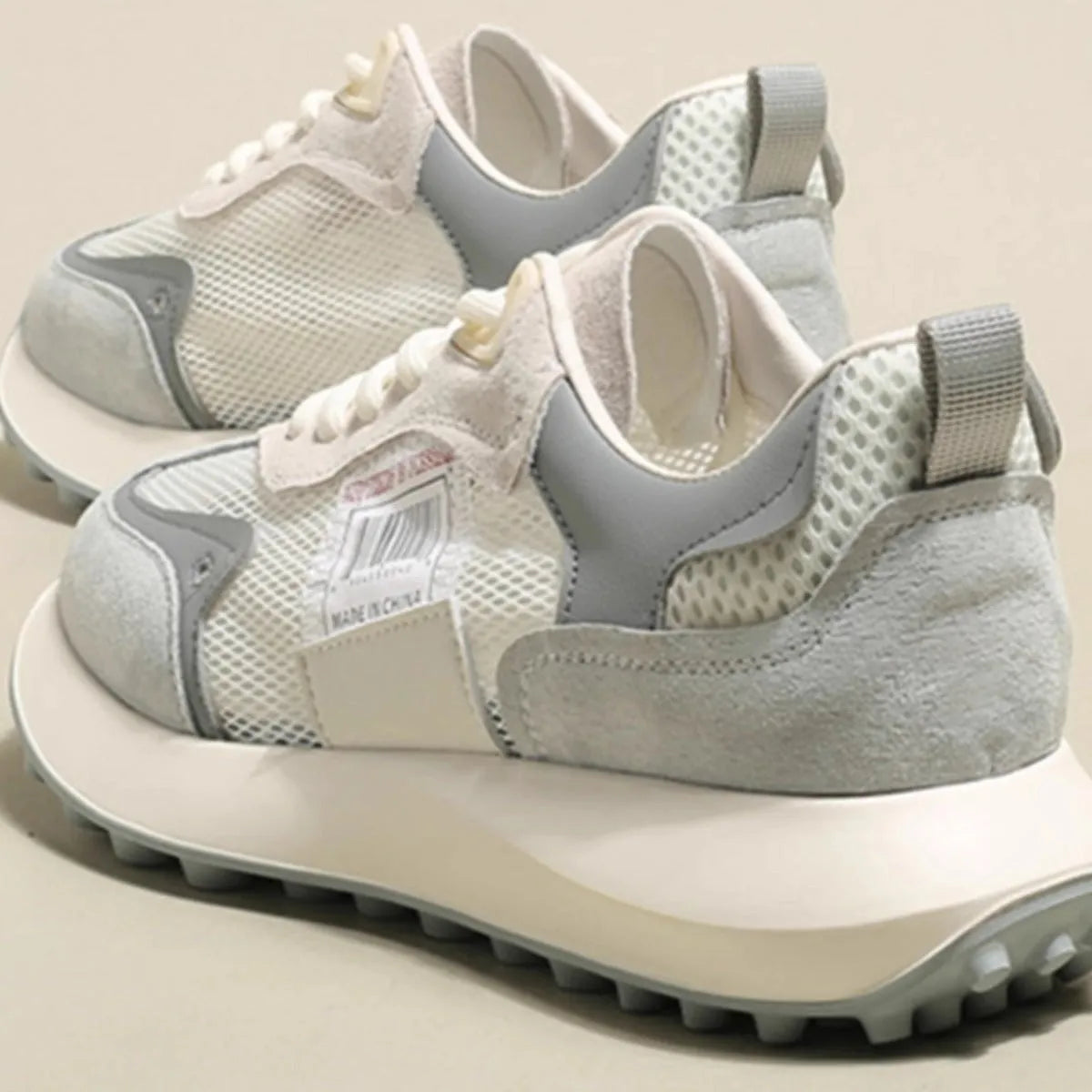 Women's grey and pink retro sneaker with low-top design and rubber sole