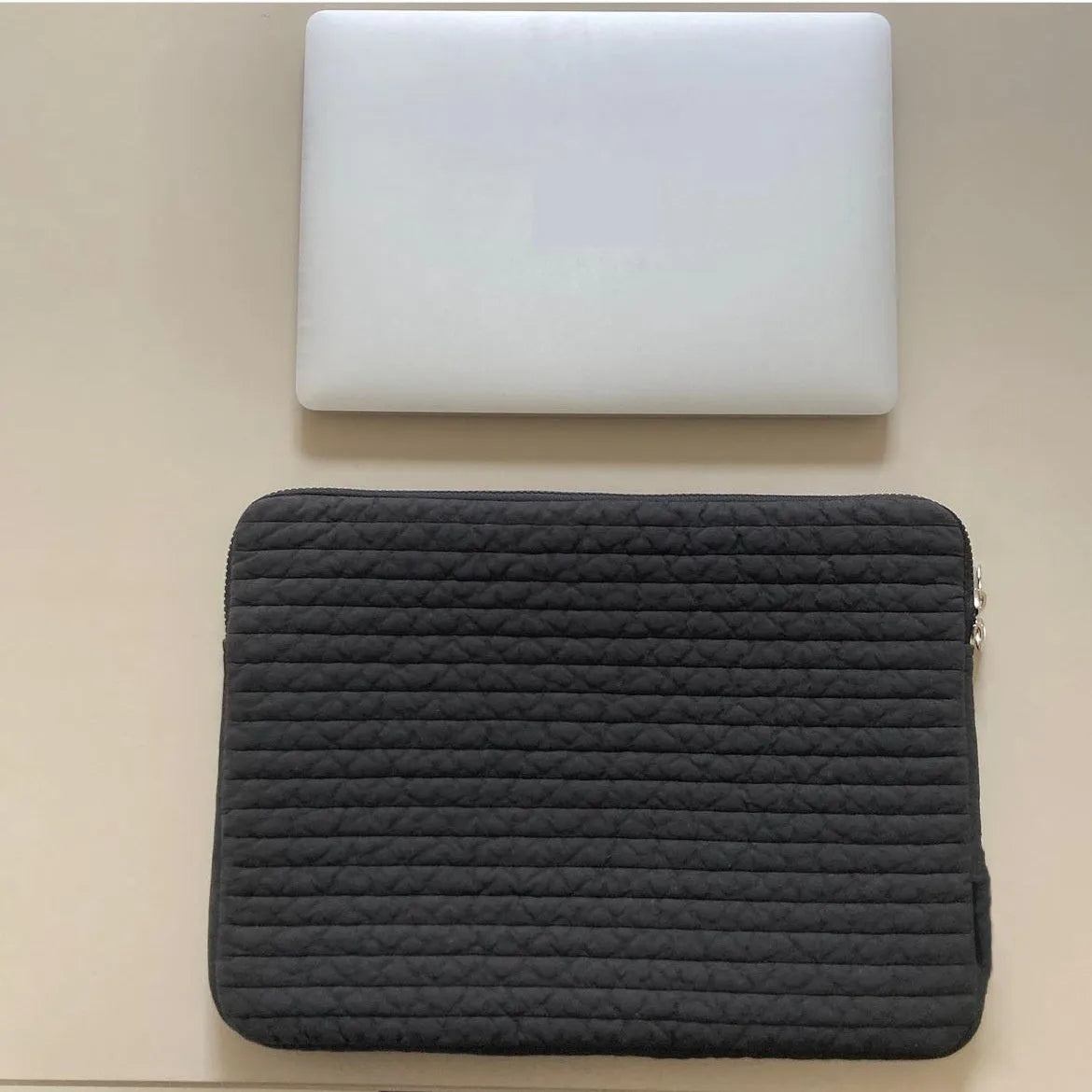 Black and white hand-held cotton cloth laptop clutch bag for tablet protection with coin pocket.