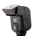 Compact silver SLR camera flash unit tilted on a hot shoe mount.